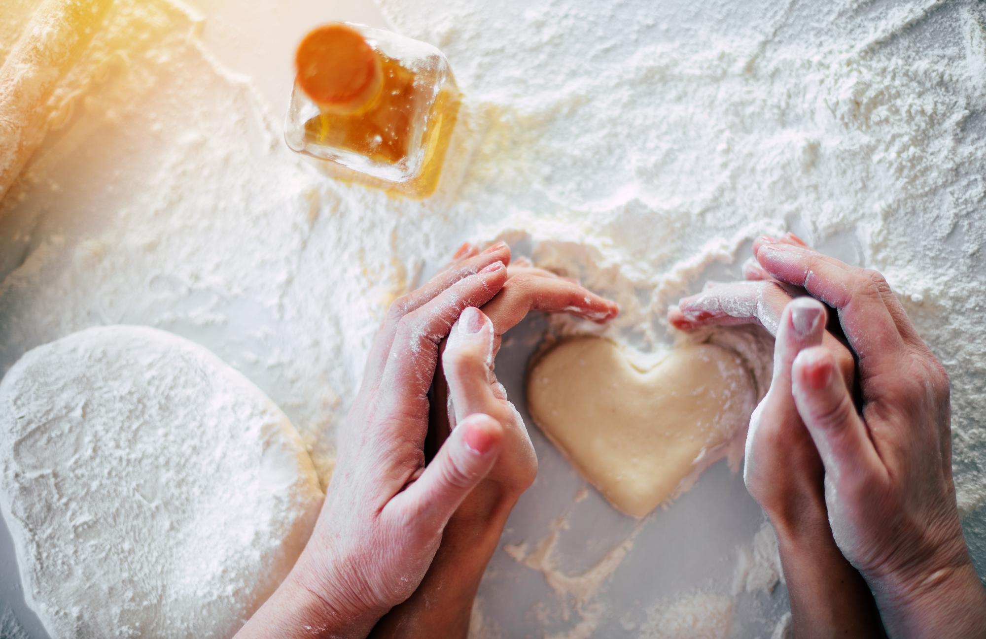 Hands kneading dough in natural light